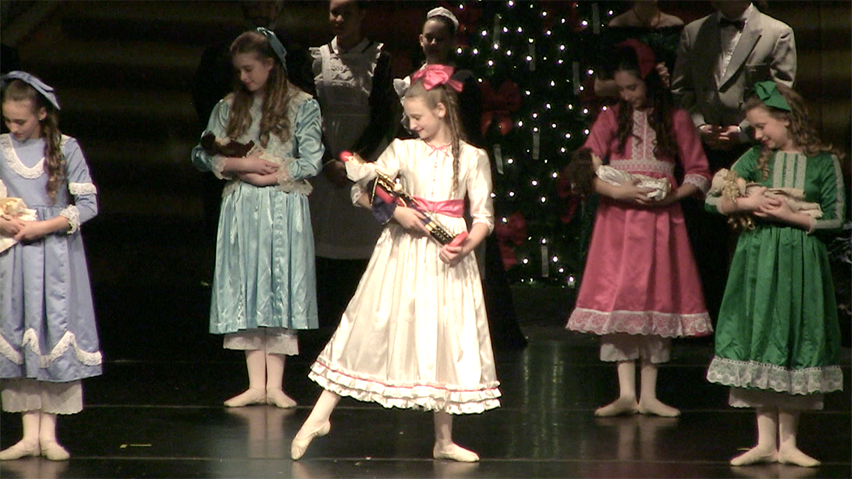 Clara holding the nutcracker in Act 1
